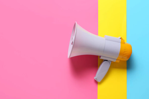 Modern megaphone on color background