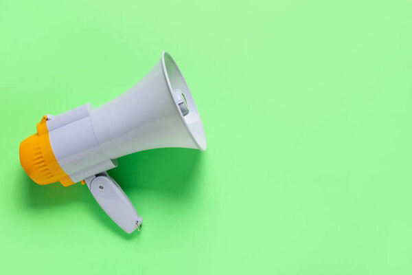 Modern megaphone on color background