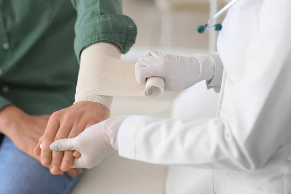 Doctor Applying Bandage Arm Young Man Clinic Closeup — Stock Photo, Image