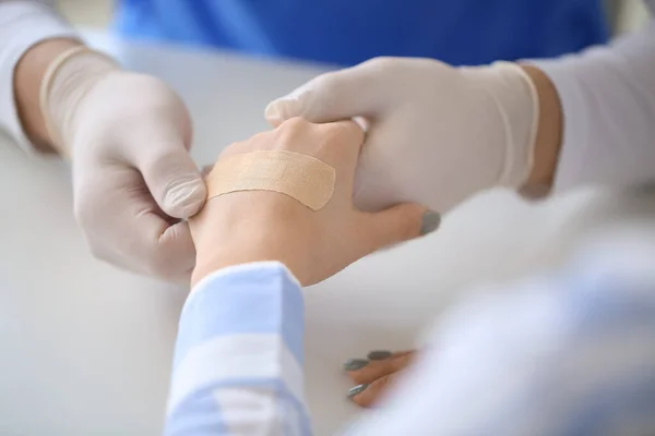 Doctor Applying Plaster Hand Young Woman Clinic Closeup — Stock Photo, Image