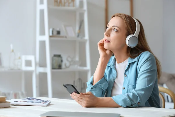 Mature Woman Mobile Phone Listening Audiobook Home — Stock Photo, Image