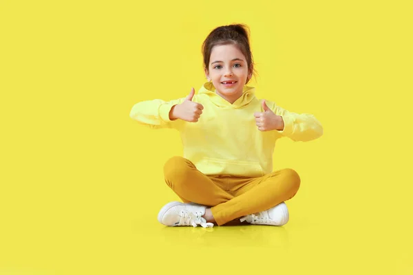 Cute Little Girl Showing Thumbs Color Background — Stock Photo, Image