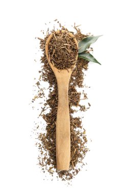 Beyaz arka planda kuru hojicha yeşil çay kaşığı.