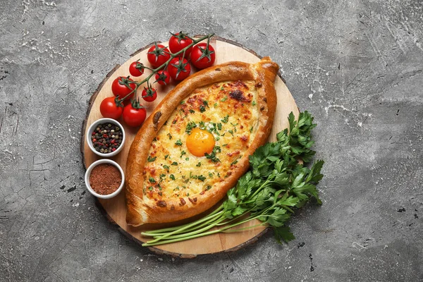 Wooden Board Tasty Ajarian Khachapuri Tomatoes Spices Grunge Background — Stock Photo, Image