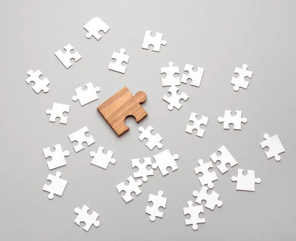 Wooden Puzzle Piece White Ones Light Background Concept Uniqueness — Stock Photo, Image