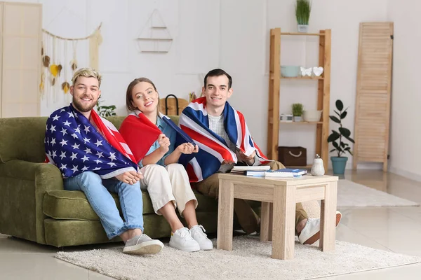 Young people with different flags at home