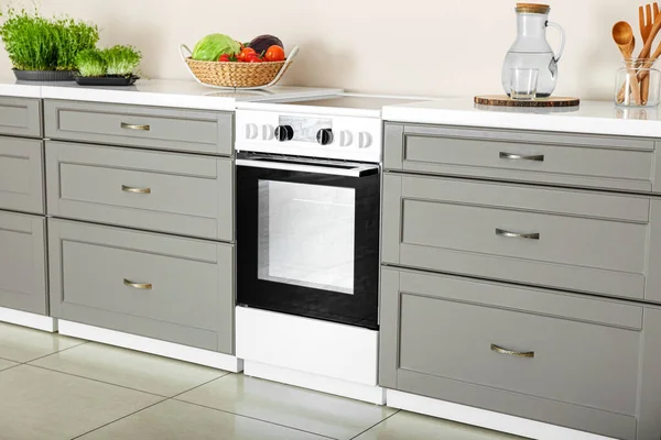 Modern furniture with electric oven in kitchen