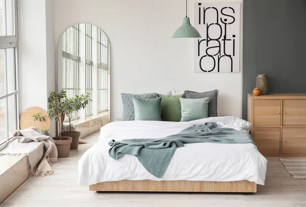 Modern interior of light bedroom with mirror