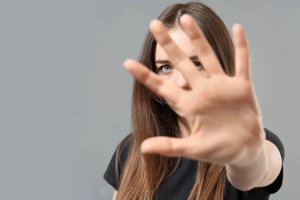 Young Woman Showing Stop Gesture Grey Background Concept Harassment — Stock Photo, Image