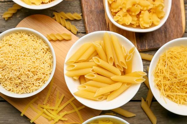 Different Types Uncooked Pasta Wooden Background — Stock Photo, Image