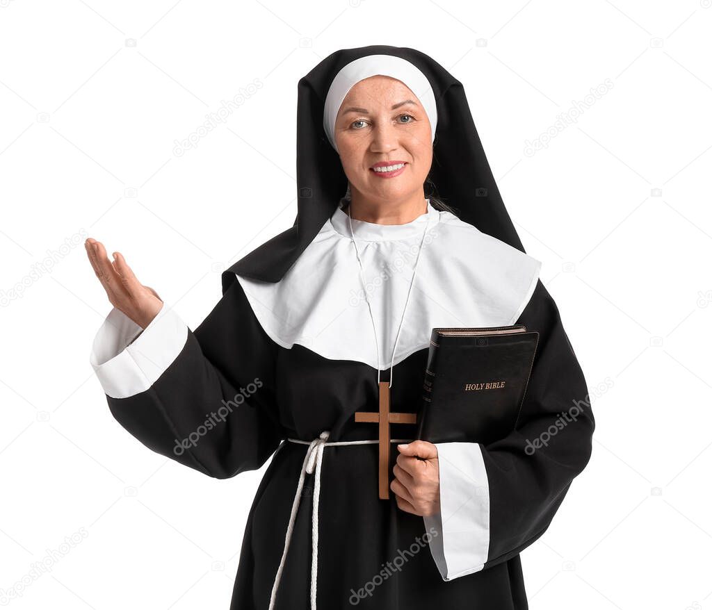 Mature nun with Holy Bible on white background