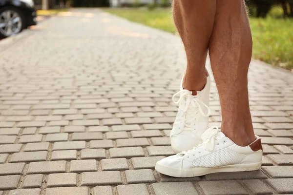 Legs of sporty young man outdoors