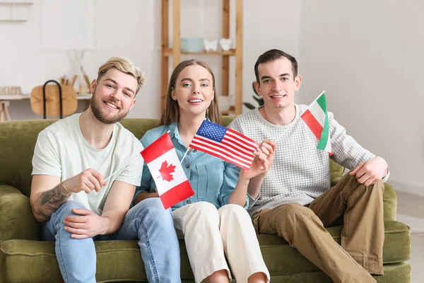 Young people with different flags at home