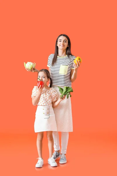 Young Mother Daughter Tasty Vegetables Color Background — Stock Photo, Image