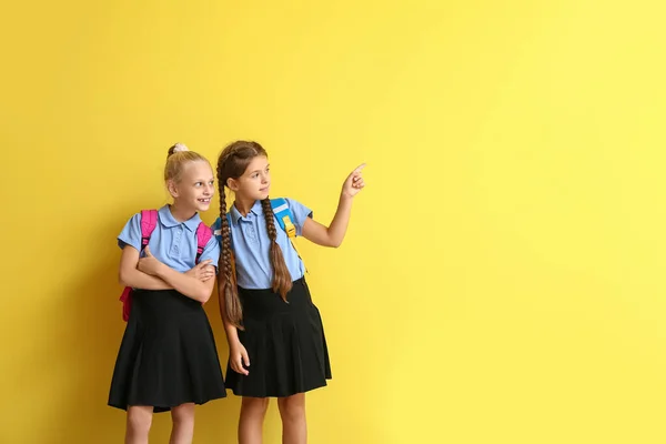 Cute Schoolgirls Pointing Something Color Background — Stock Photo, Image