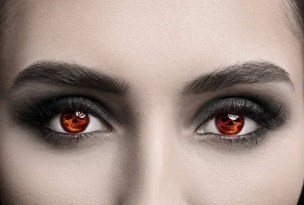 Young woman wearing creative contact lenses for Halloween party, closeup