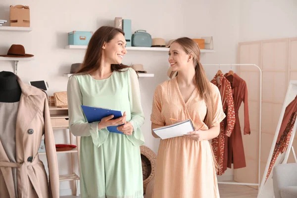 Female business owner and seller working in shop