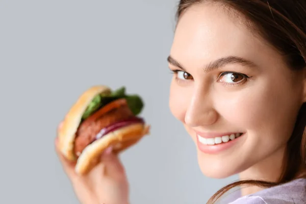 Beautiful Young Woman Tasty Vegan Burger Grey Background — Stock Photo, Image