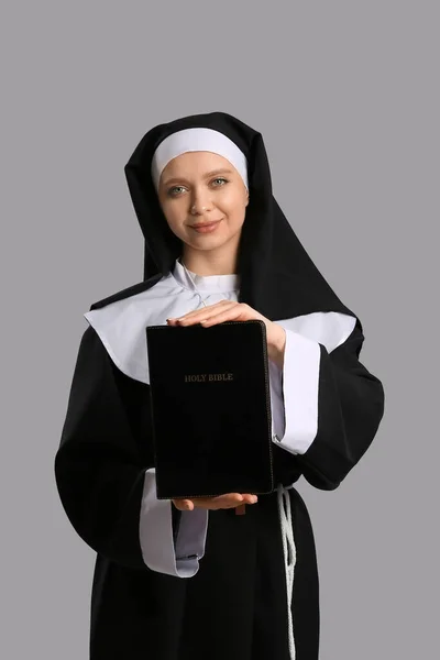 Ung Nunna Med Bibeln Grå Bakgrund — Stockfoto