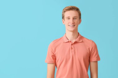 Arkaplanda diş teli olan yakışıklı bir adam.