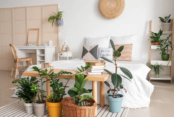 Interior of stylish bedroom with plants