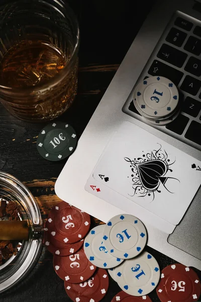 Poker Chips Playing Cards Glass Beverage Laptop Dark Wooden Background — Stock Photo, Image