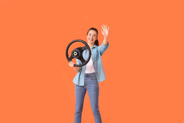 Young Woman Steering Wheel Waving Hand Color Background — Stock Photo, Image