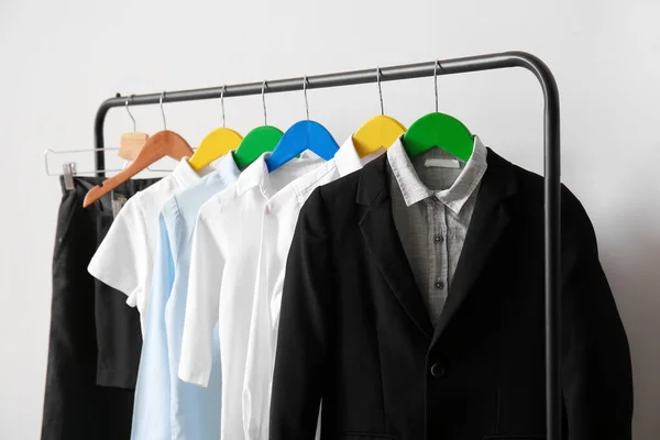 Rack Met Stijlvol Schooluniform Buurt Van Lichtmuur — Stockfoto