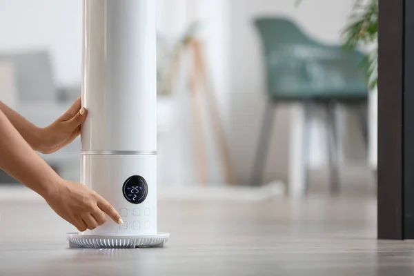 Woman Switching Modern Air Humidifier Home — Stock Photo, Image