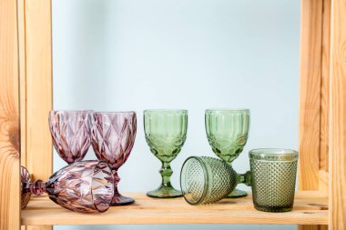 Renk duvarının yanındaki raf ünitesinde boş bardaklar