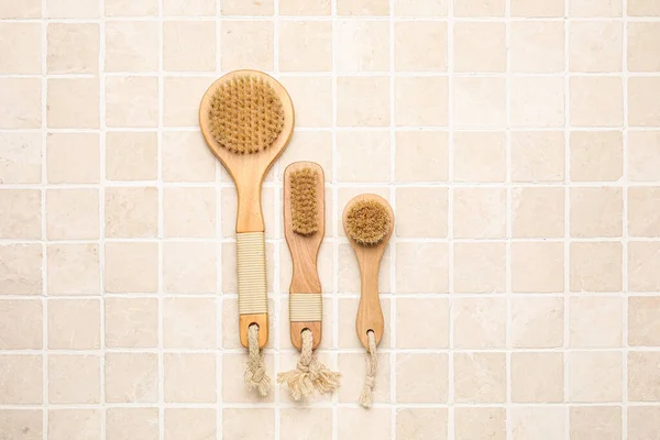 Different Massage Brushes Light Tile Background — Stock Photo, Image