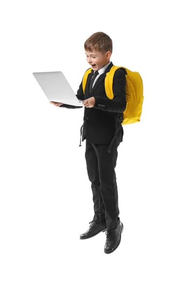 Springender Kleiner Schuljunge Mit Laptop Auf Weißem Hintergrund — Stockfoto