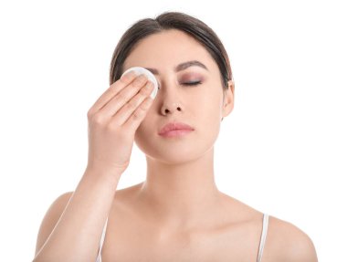 Beyaz arka planda pamuk pedi olan güzel bir Asyalı kadın.