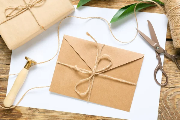 stock image Envelope with stamp, scissors and box on wooden background