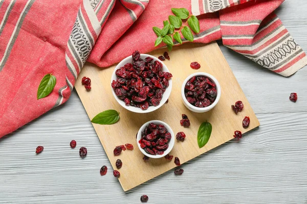 Bowls Tasty Dried Cranberries Color Wooden Background — Stock Photo, Image