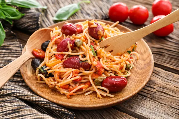 Plate Tasty Pasta Puttanesca Wooden Background — Stock Photo, Image