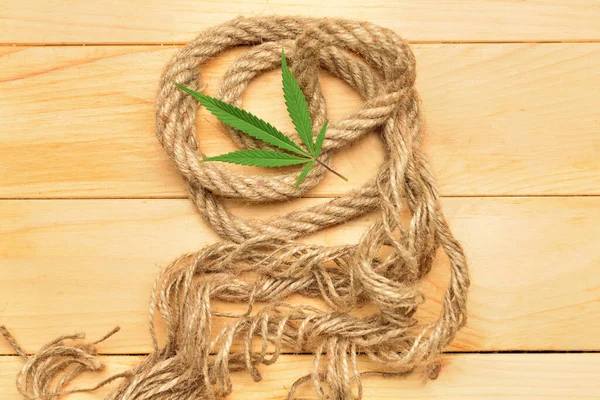 Hemp rope on wooden background