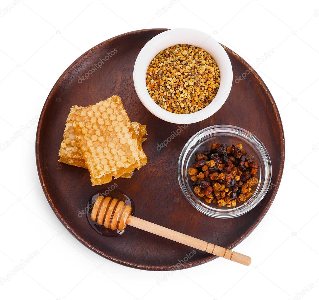 Plate with honey and bee products on white background