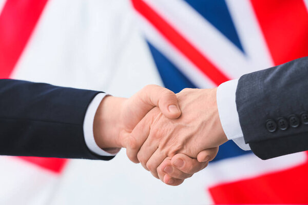 Business people handshaking against the flags of Great Britain and England