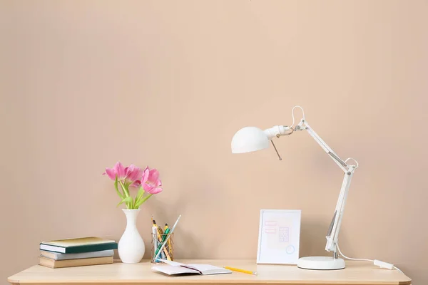 Elegante Lugar Trabajo Con Hermosas Flores Lámpara Moderna Cerca Pared — Foto de Stock