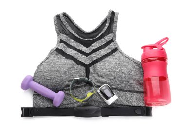 Beyaz zemin üzerinde spor öğeleri ve nabız oksimetresi kümesi