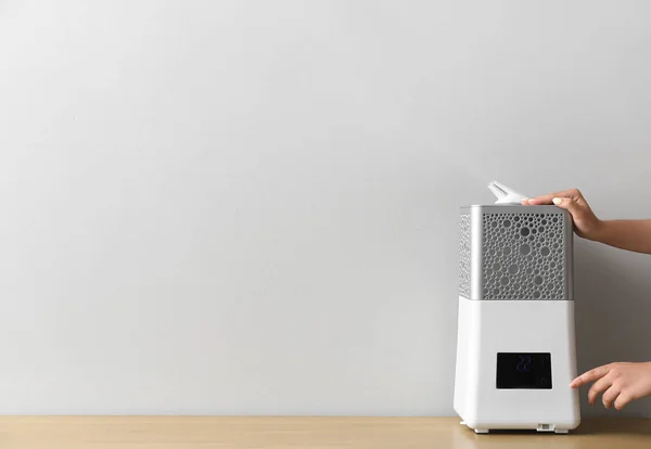 Woman Switching Modern Humidifier Table — Stock Photo, Image