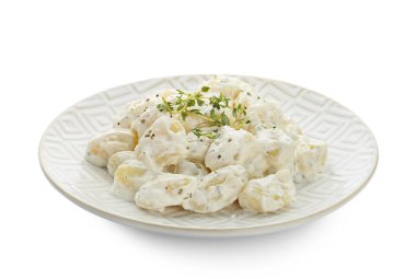 Beyaz arka planda krem soslu lezzetli gnocchi tabağı.