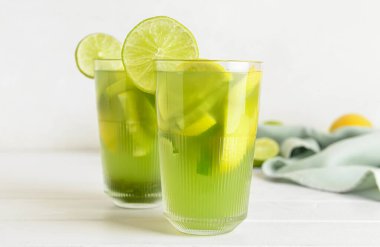 Hafif ahşap arka planda lezzetli limonatalı bardaklar.