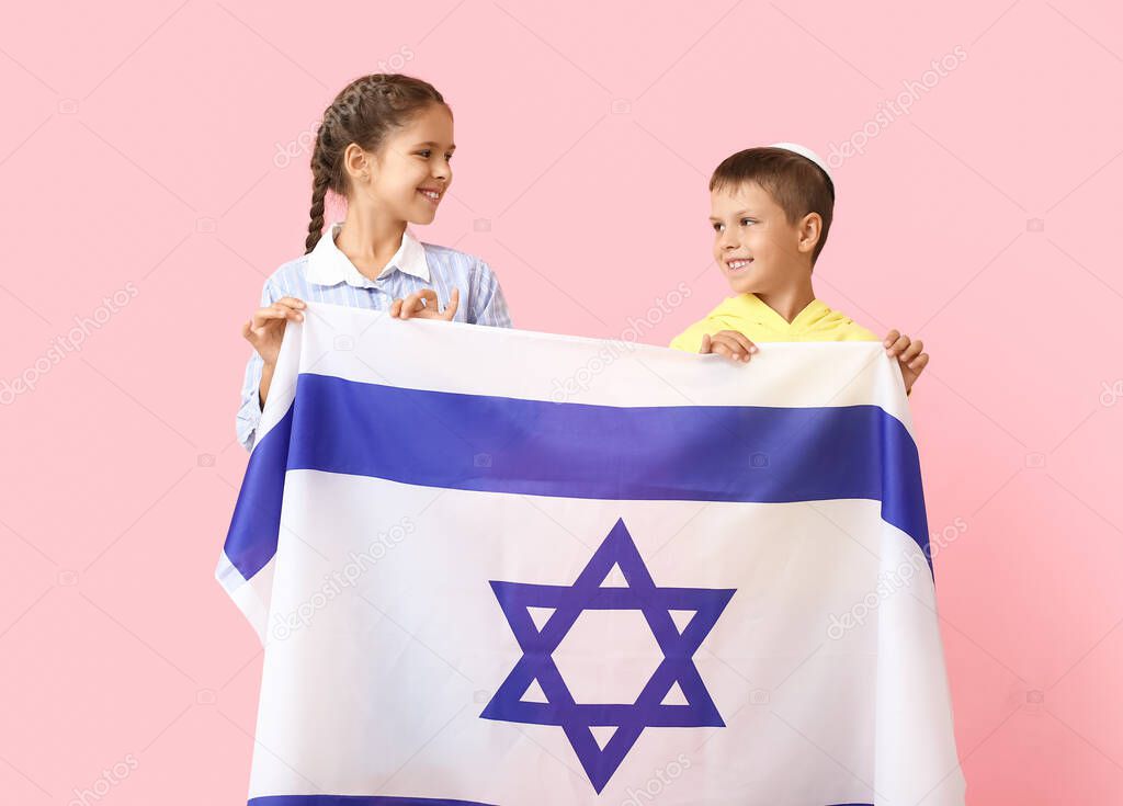 Little children with the flag of Israel on color background