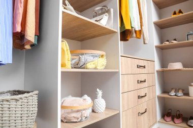 Giysileri ve organizatörleri olan modern gardırop.