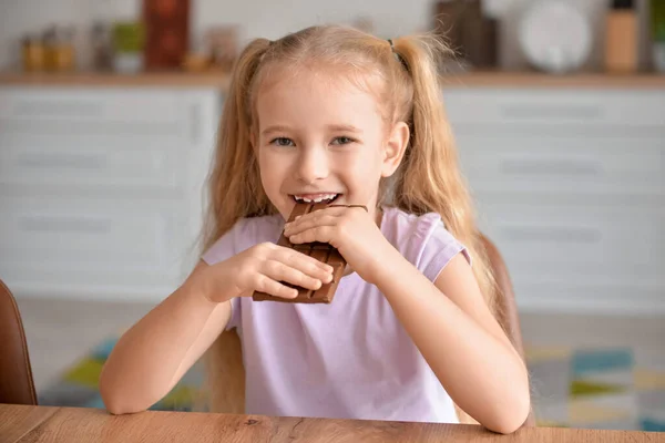 Cute Little Girl Eating Sweet Chocolate Kitchen — Stock Photo, Image