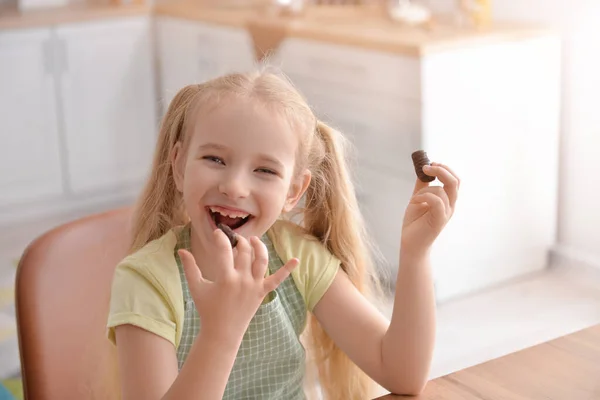 Cute Little Girl Eating Sweet Chocolate Kitchen — Stock Photo, Image