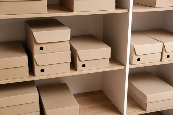 Many cardboard boxes on shelves in wardrobe