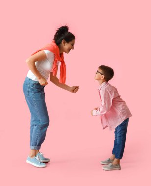 Dans eden genç kadın ve küçük oğlu renkli arka planda